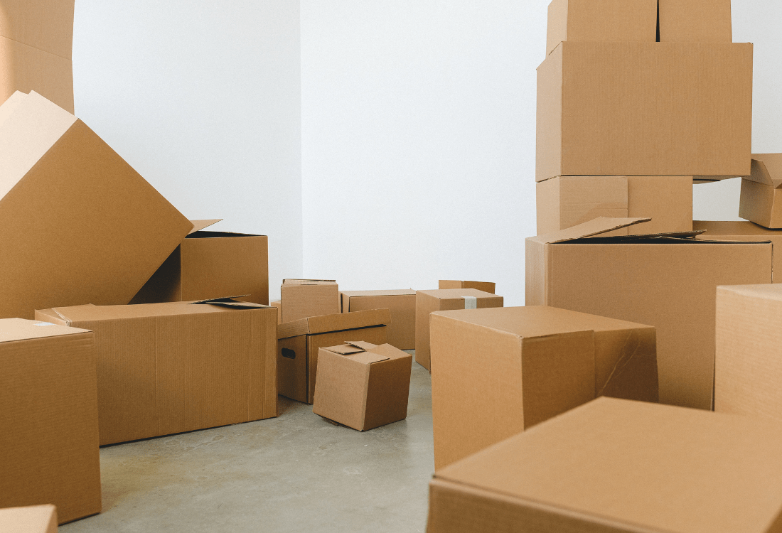 Lots of boxes stacked in the corner of the room symbolising corporate relocation 